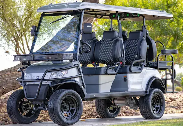 EPIC e60L lifted 6-passenger electric golf cart in silver with black diamond-stitched seats, front LED light bar, and rugged wheels for Sarasota group travel