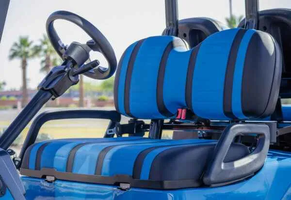 Plush blue and black seating in ICON i40 electric golf cart with seatbelts and armrests
