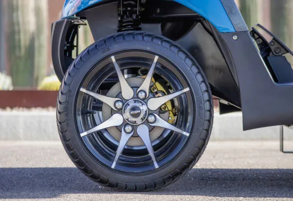 Close-up of premium black and chrome rims on ICON i40 golf cart with lifted tires