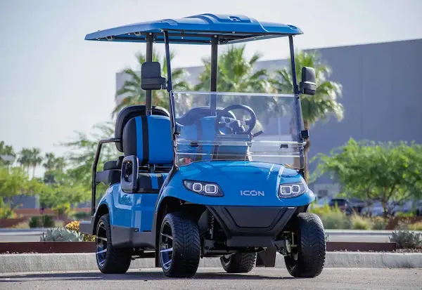 Blue ICON i40 golf cart parked in Florida neighborhood with lifted stance and street-legal design